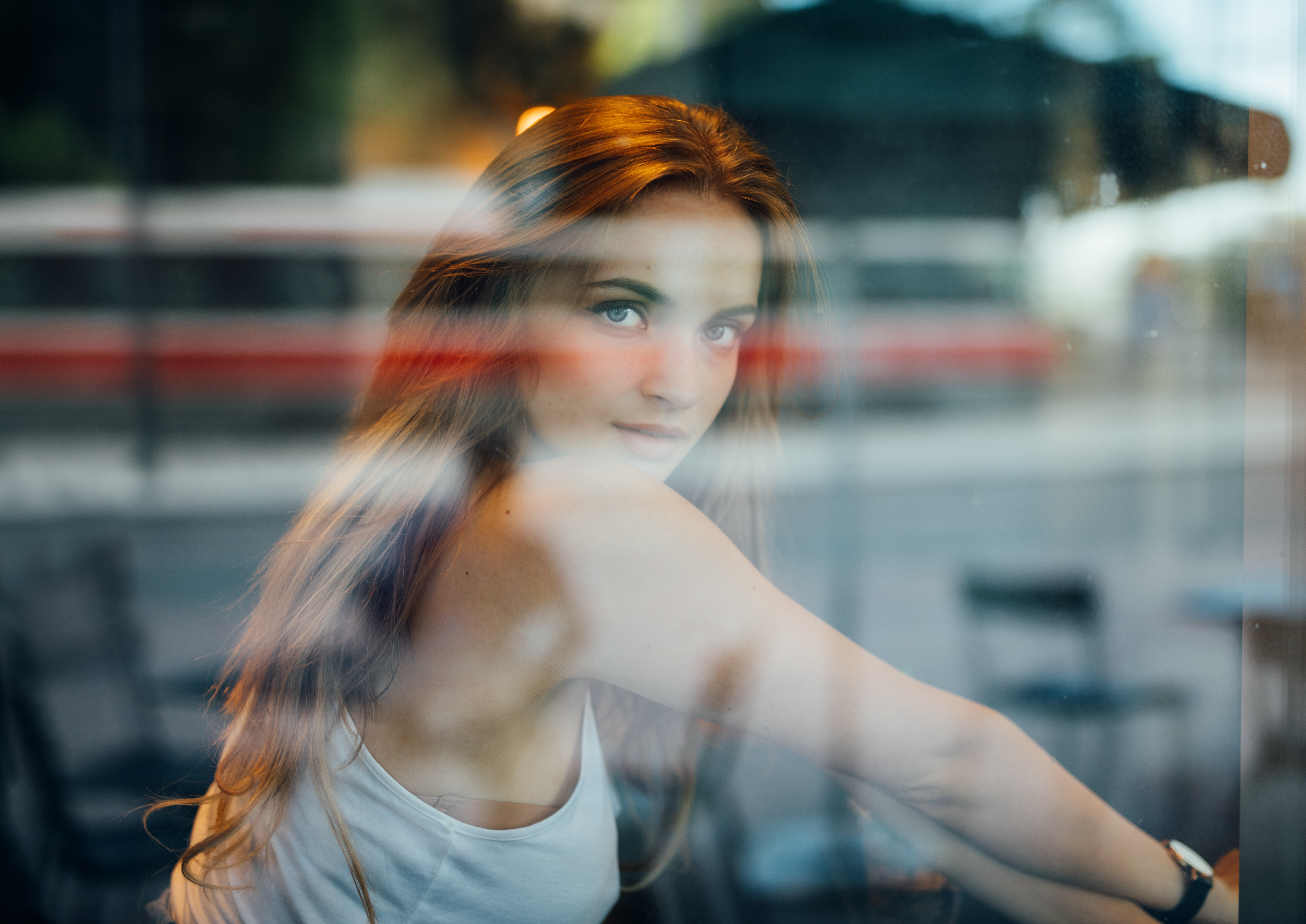 Woman with long blonde hair looking through a window HD Wallpaper