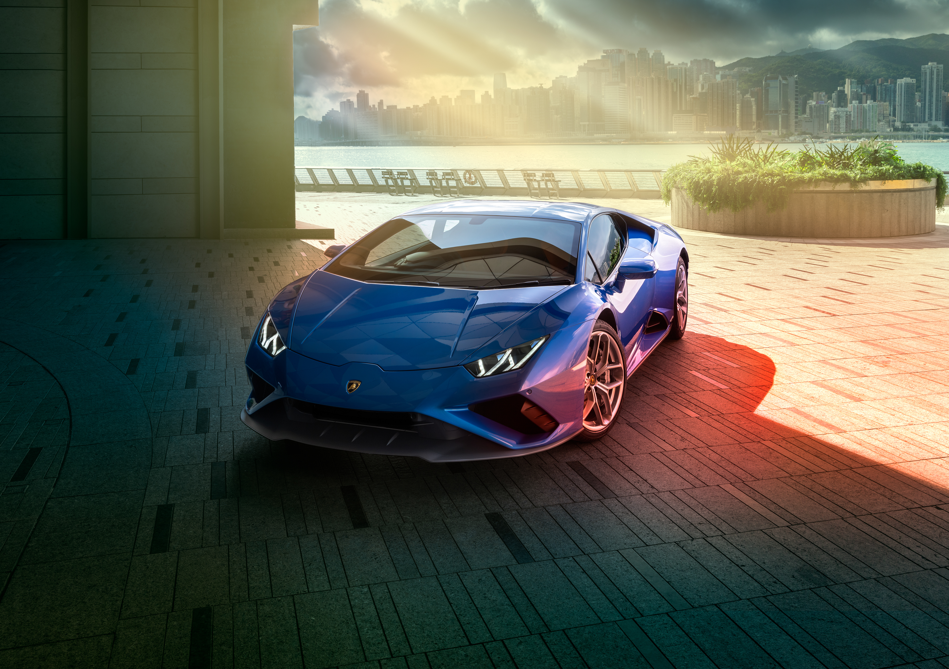 Blue Lamborghini Huracan parked by a waterfront city HD Wallpaper