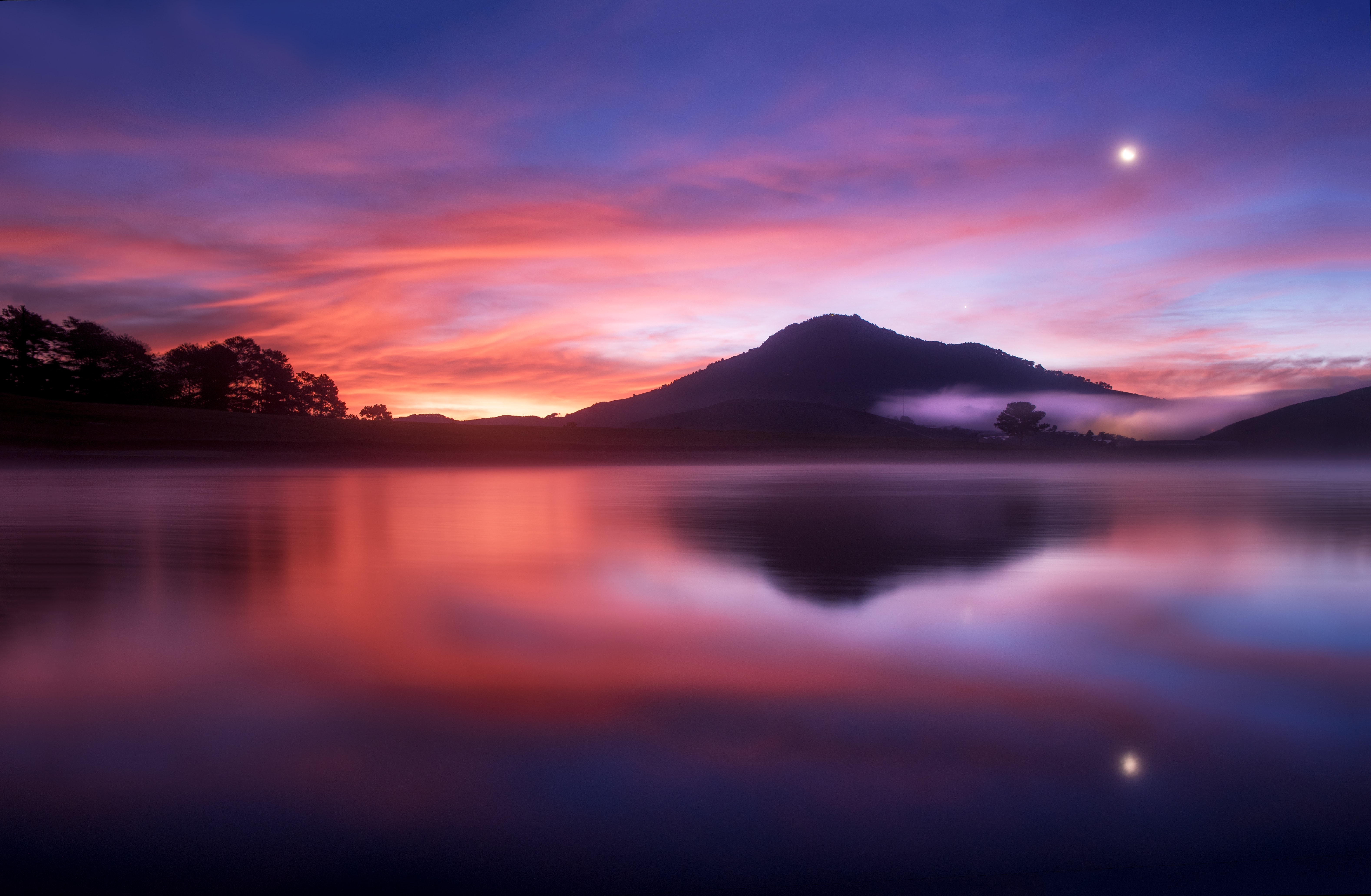 Sunset over a misty lake with mountains HD Wallpaper