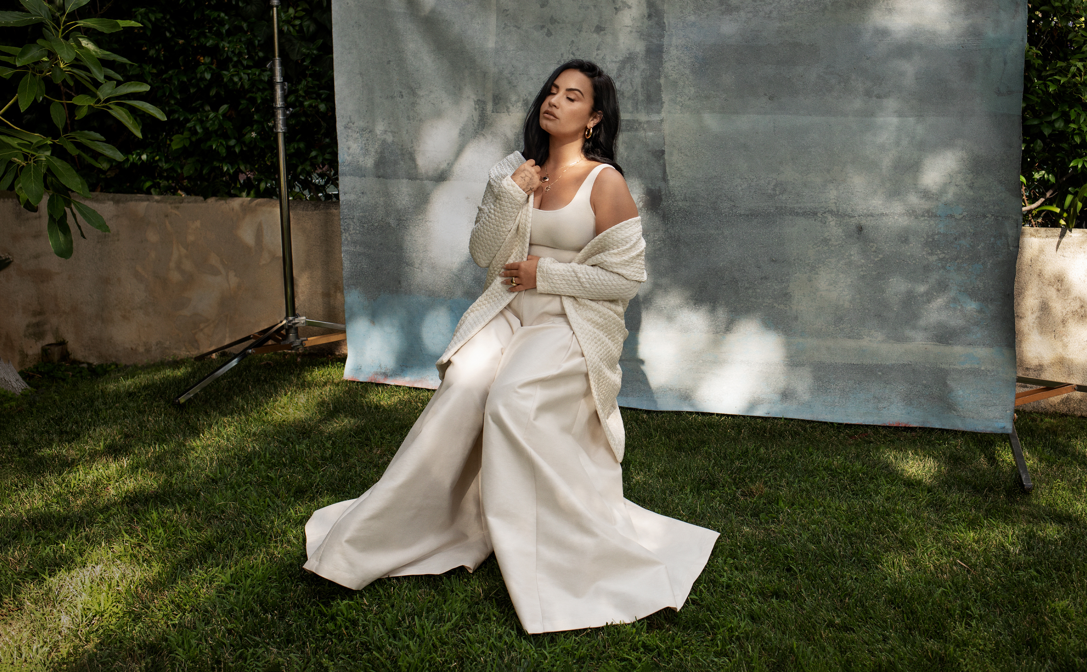 Demi Lovato sitting outdoors HD Wallpaper