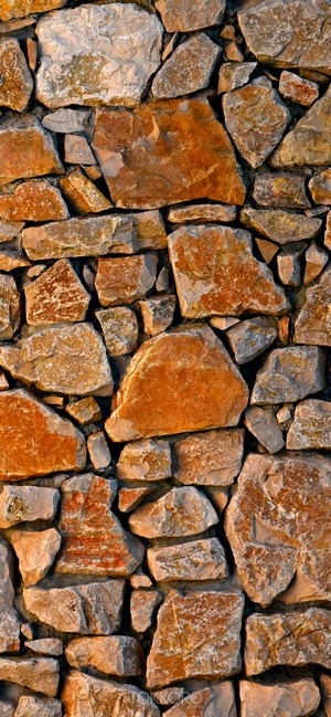 Stone wall texture with rough, irregular rocks