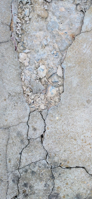 Cracked concrete texture with rubble