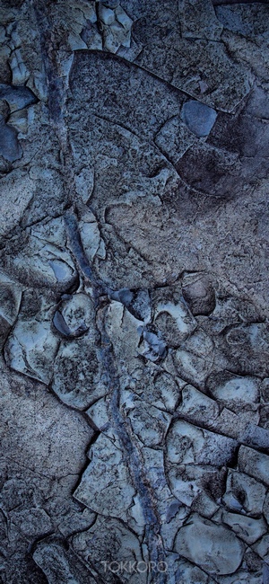Cracked rock surface with blue vein