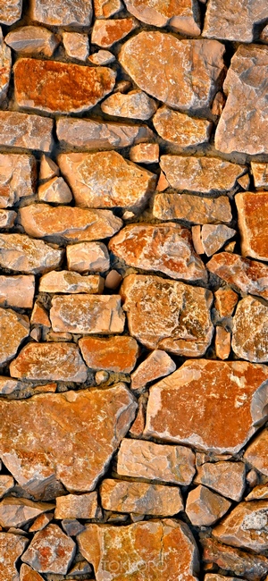 Stone wall texture with rough, irregular stones