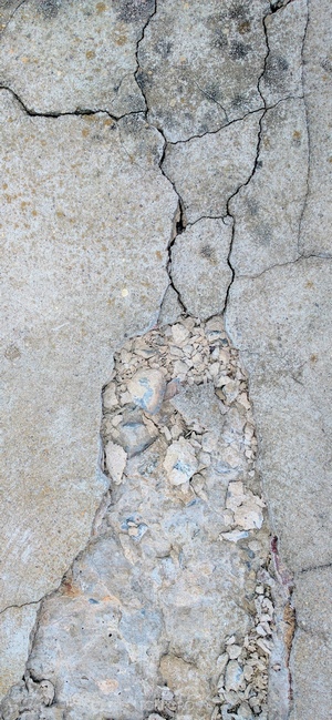 Cracked concrete texture with broken pieces