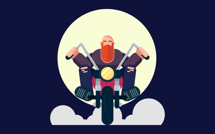 Biker riding a motorcycle in front of a large moon