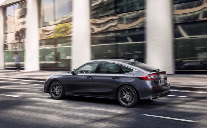 2022 Honda Civic Hatchback Sport Touring driving on city street