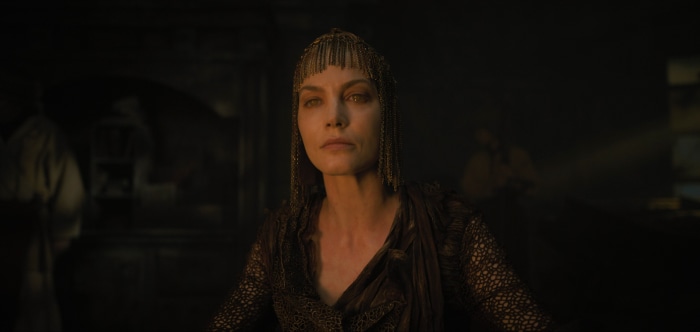 Sylvia Hoeks in ornate headpiece and dark dress