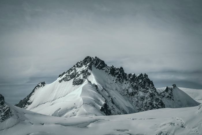 Snowy Mountain Peaks Under Cloudy Sky 4K