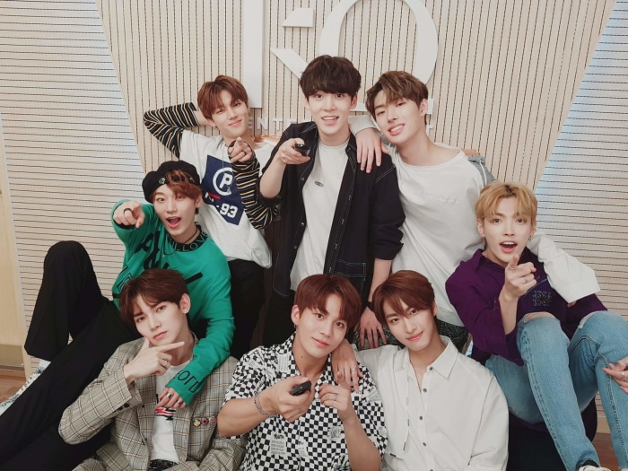 ATEEZ members posing for a group photo