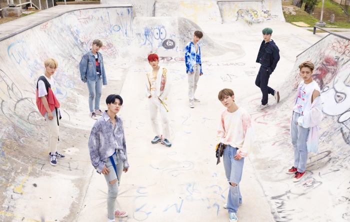 ATEEZ members in a skate park