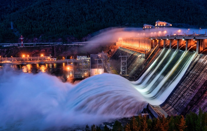 Hydroelectric dam at night with water flowing