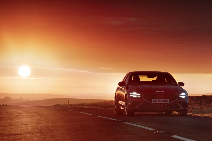 Genesis G70 2.0T on a road at sunset