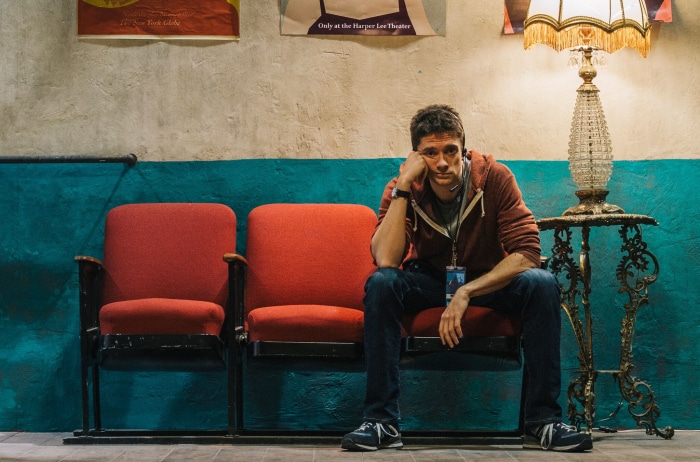Topher Grace sitting in theater seats
