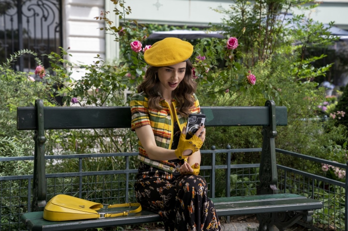 Lily Collins as Emily in Paris on a bench