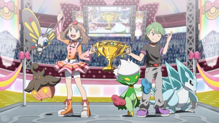 May and Drew with Pokémon and trophy