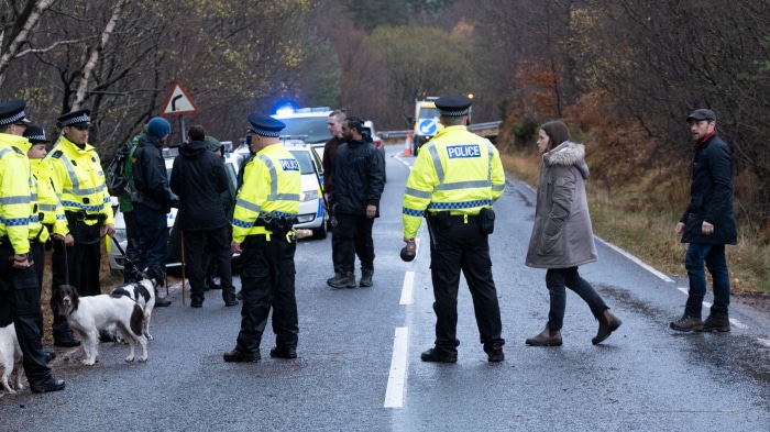 Police officers and civilians on a road