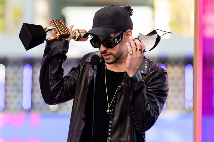 Bad Bunny holding award and mask