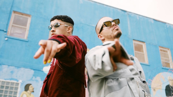 Bad Bunny and Jowell in front of a blue mural