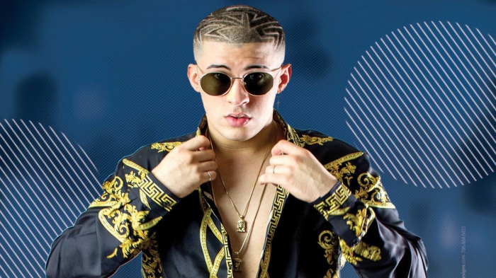 Bad Bunny wearing sunglasses and a patterned shirt