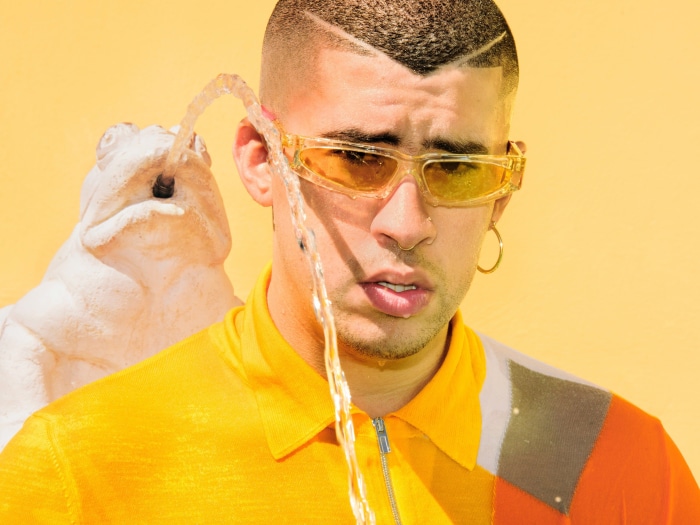 Bad Bunny wearing sunglasses with water splashing