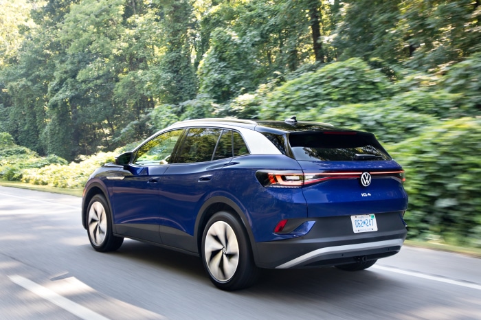 Blue Volkswagen ID.4 AWD Pro S driving on a road
