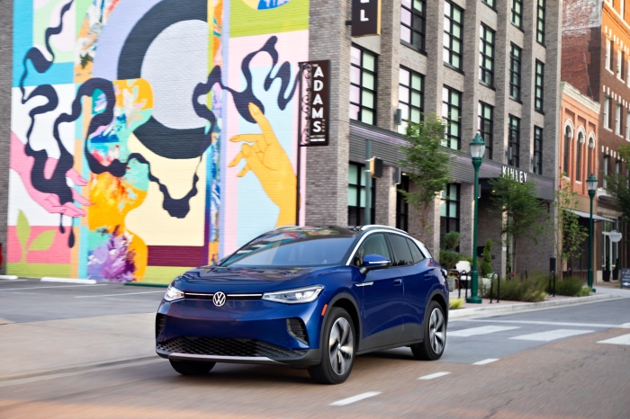 Blue Volkswagen ID.4 electric car driving on city street