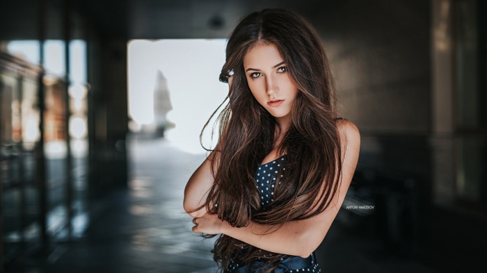 Brunette woman with long hair in a polka dot dress