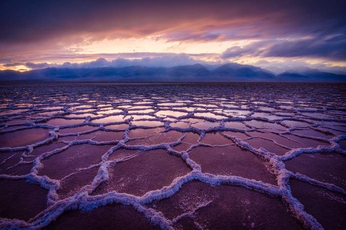 Salt flats at sunset with mountains