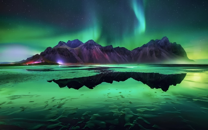 Aurora Borealis over Icelandic Mountains and Reflection