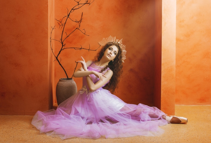Ballerina in a purple dress with a golden crown