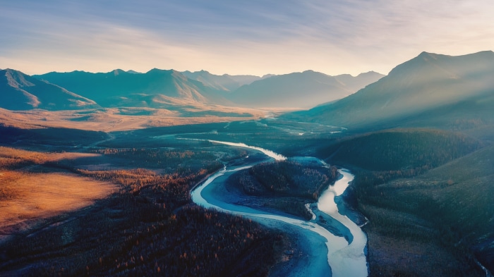 River valley with mountains at sunset