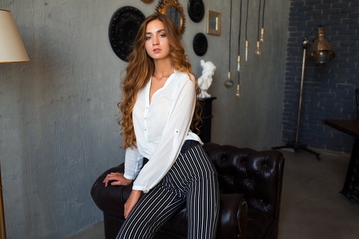 Redhead woman in white shirt and striped pants