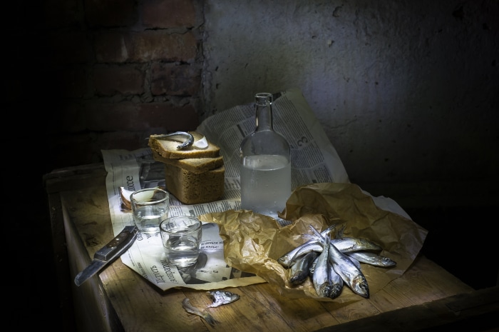 Still life with bread, fish, vodka, and knife