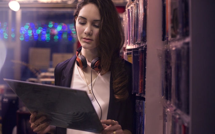 Woman holding a vinyl record in a store