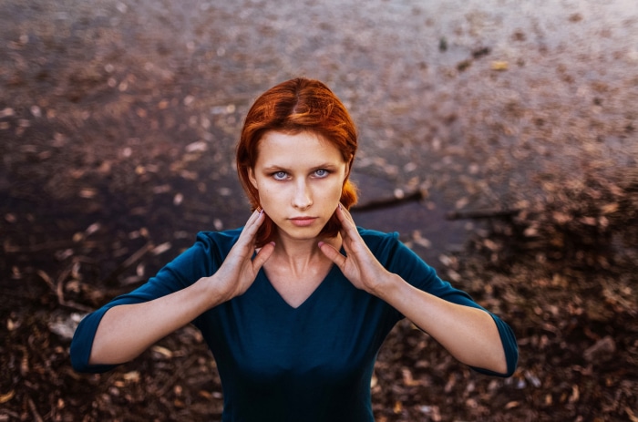Redhead woman with blue eyes in teal dress