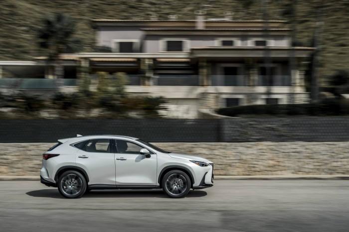 White Lexus NX 250 driving on road