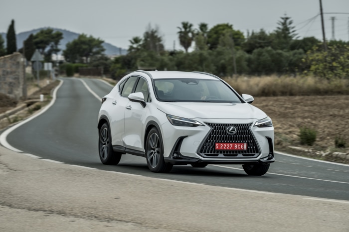 White Lexus NX 250 driving on a road
