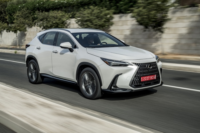 White Lexus NX 250 driving on a road