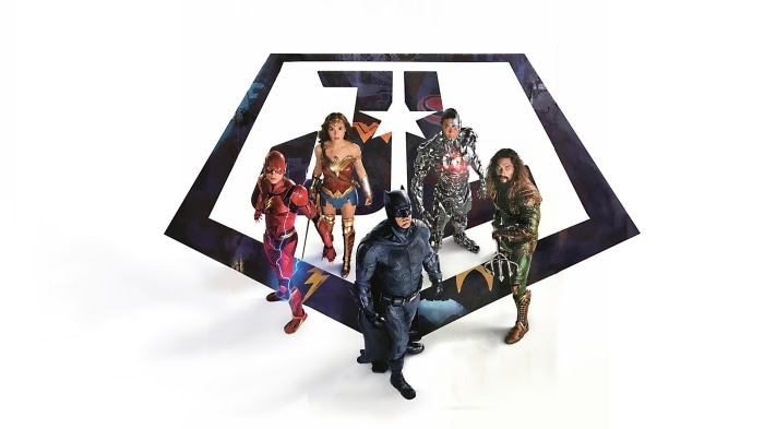 Justice League characters standing in front of logo