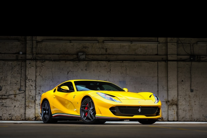 Yellow Ferrari 812 Superfast parked in a warehouse