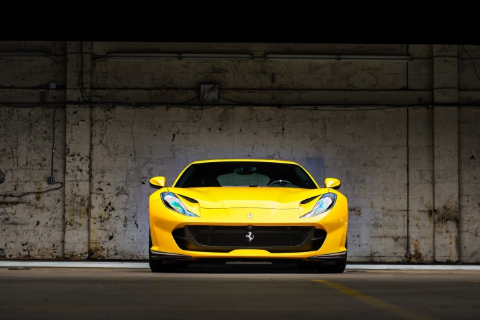 Yellow Ferrari 812 Superfast parked in a garage