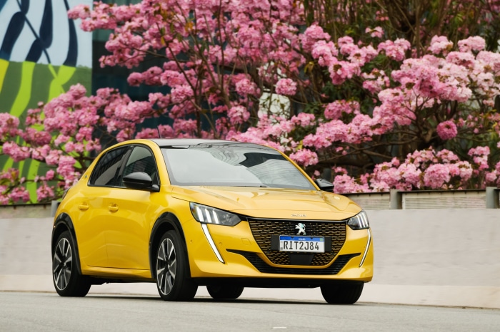 Yellow Peugeot E-208 GT electric car with pink flowers