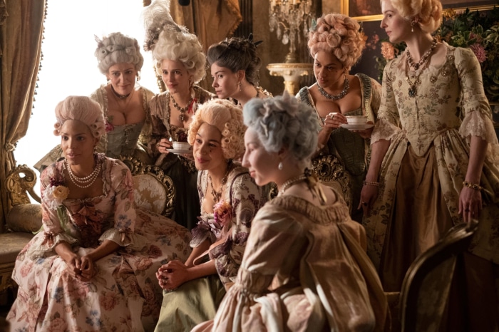 Women in 18th-century attire and wigs