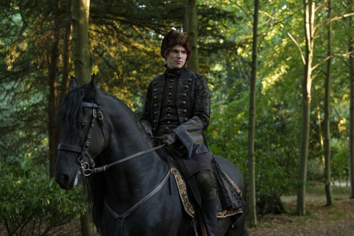 Nicholas Hoult on a horse in a forest