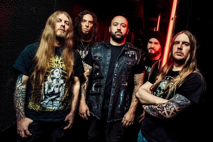 Benighted band members posing for a photo