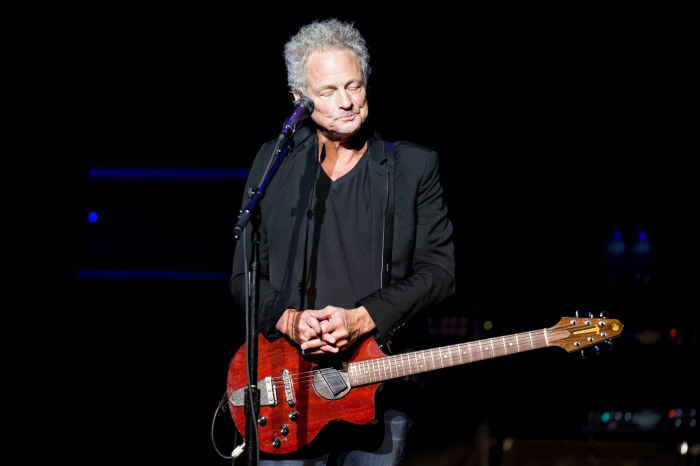 Lindsey Buckingham performs with his guitar