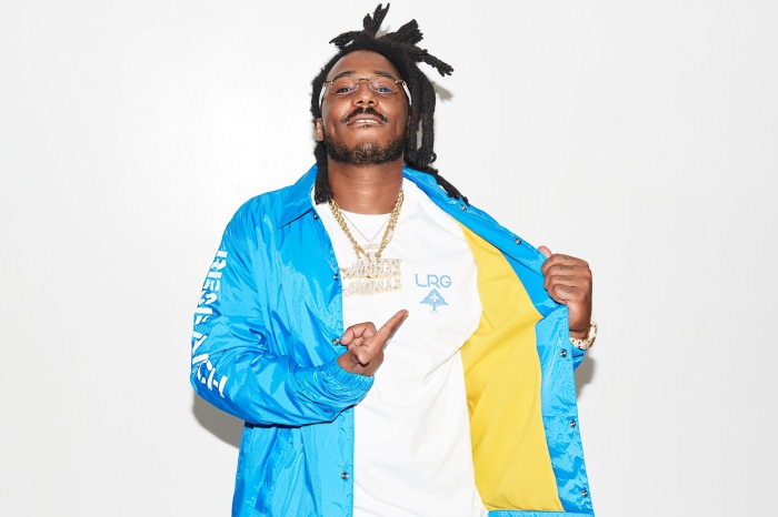 Mozzy wearing LRG shirt and blue jacket