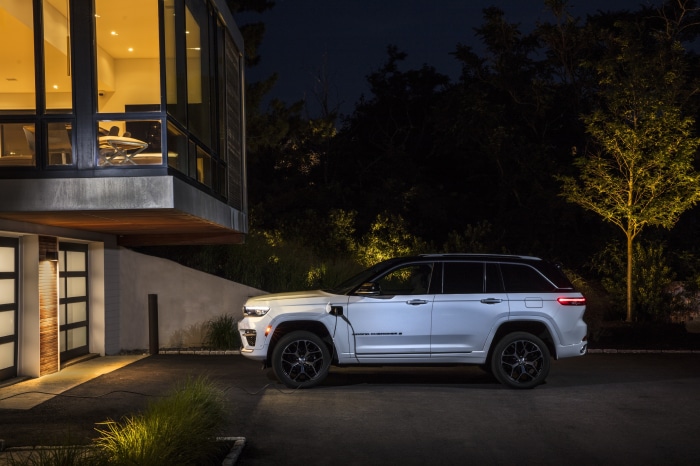 2022 Jeep Grand Cherokee Summit Reserve 4xe charging at modern house