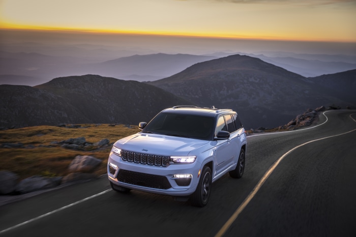 White Jeep Grand Cherokee Summit Reserve 4xe on mountain road